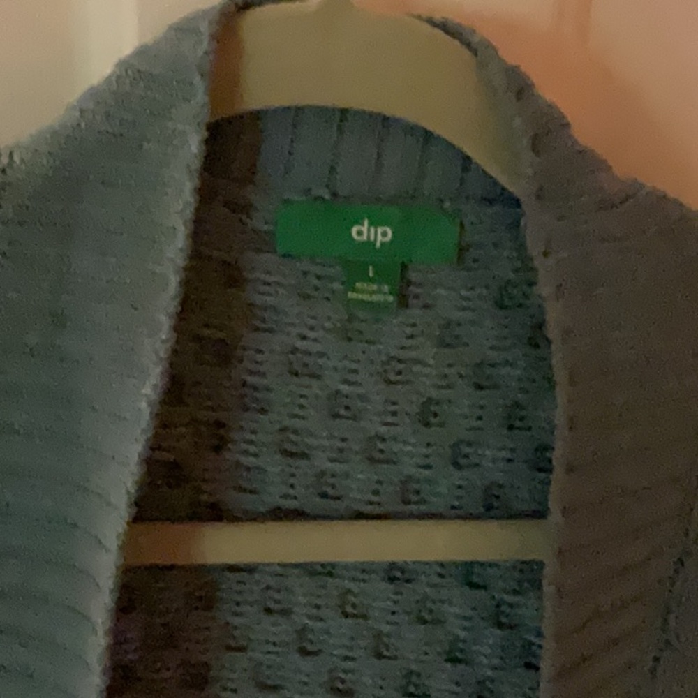 Lovely greenish cozy cardigan.  Large but  a very generous large.